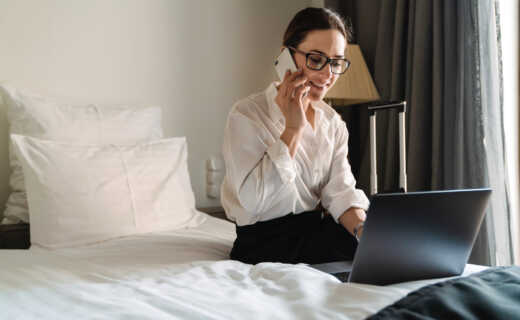 Female business traveller working in her corporate apartment